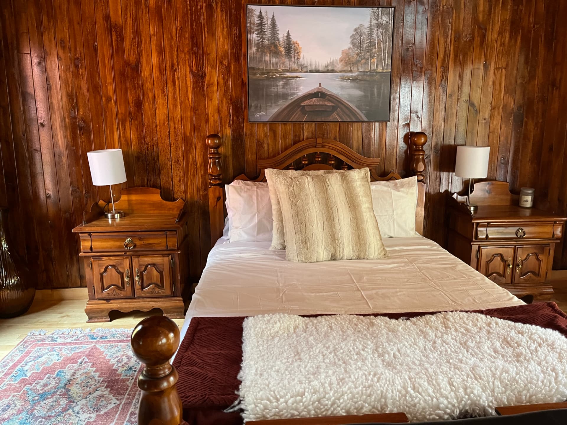 Beautiful cottage bedroom with wood panelling and layered bedding